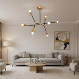 Berlin 8 light black and brass linear arm chandelier shown from an angled view with exposed globe bulbs.