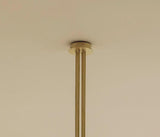 Close-up of brass ceiling canopy and downrod with smooth brushed finish and solid construction.