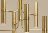 Close-up of cylindrical brass shades showing brushed finish and warm downward lighting