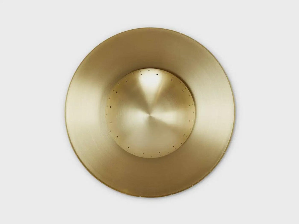 Top-down view of handcrafted brass disc flushmount ceiling light with circular sculpted form.