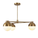 Side view of 3-light brushed brass chandelier featuring spherical frosted glass globes on a linear frame for balanced, modern illumination.