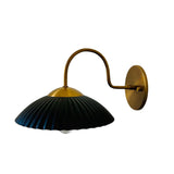 Reverse angled view of Cambria ribbed dome wall sconce with black shade and aged brass hardware – Model 32785