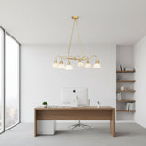 Casablanca 6 light sculptural chandelier shown from the side with curved brass-tone arms and six white dome shades.