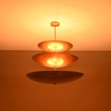 Close up of Celeste Triple Saucer Pendant Light highlighting warm light diffused through layered saucer shades.