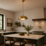 Chelsea 1 light brass dome pendant chandelier installed above a kitchen island in a warm contemporary kitchen interior.