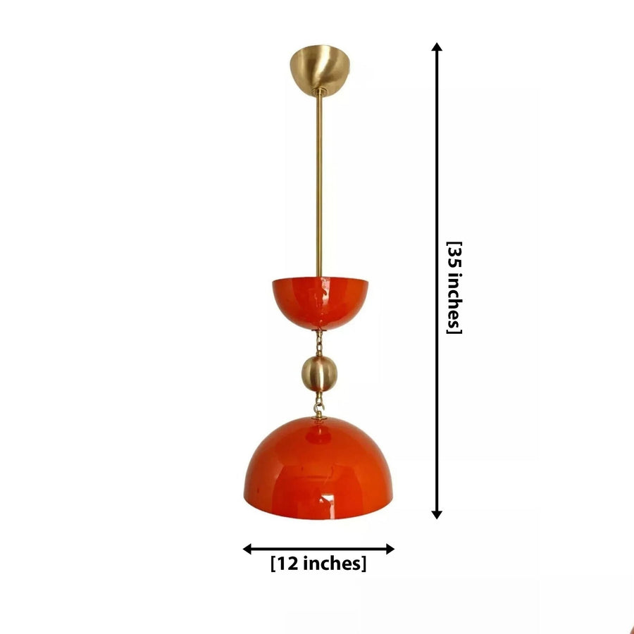 Cologne 1 light orange-red sculptural dome pendant displayed above a kitchen island with warm brass accents and olive green cabinetry.