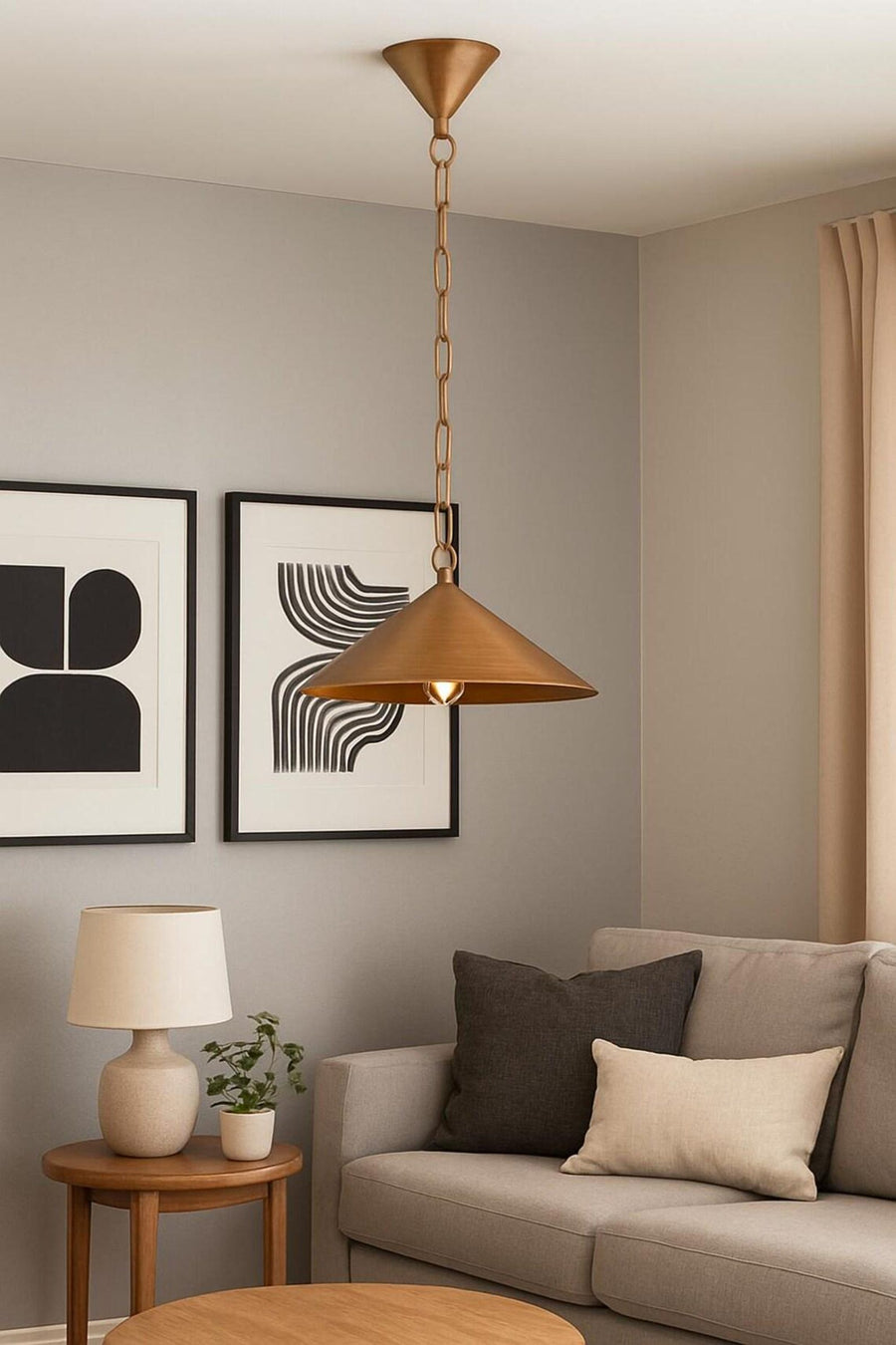 Brushed brass cone pendant chandelier with chain hanging in a narrow hallway with light wood flooring.