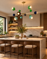 Crete 12 light multicolor Sputnik chandelier illuminated above a marble kitchen island in a warm modern kitchen interior.