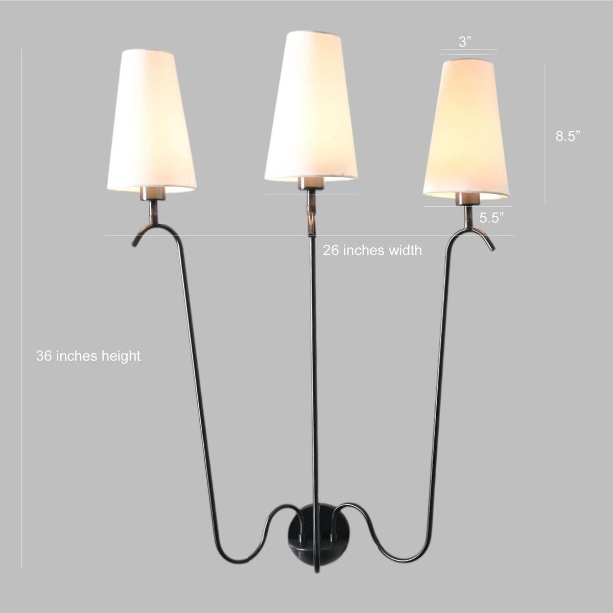 Front view of three-light wall sconce displaying dimensions of 36-inch height and 26-inch width, featuring black curving arms and fabric shades.