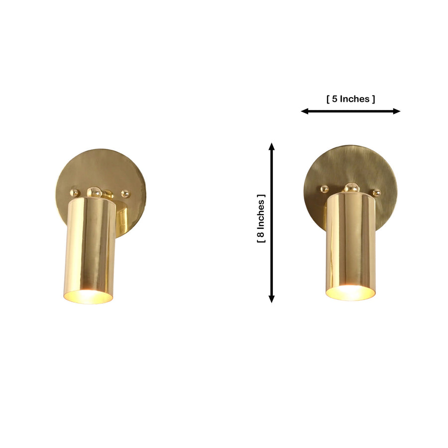 Pair of Milan adjustable antique brass cylinder wall sconces installed beside a bathroom vanity mirror, providing elegant task and accent lighting.