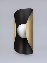 Modern curved wall lamp in black and brass finish showcasing sculptural silhouette and minimalist contemporary design