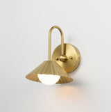 Side angle view of modern solid brass wall sconce with fluted shade and minimalist curved arm design