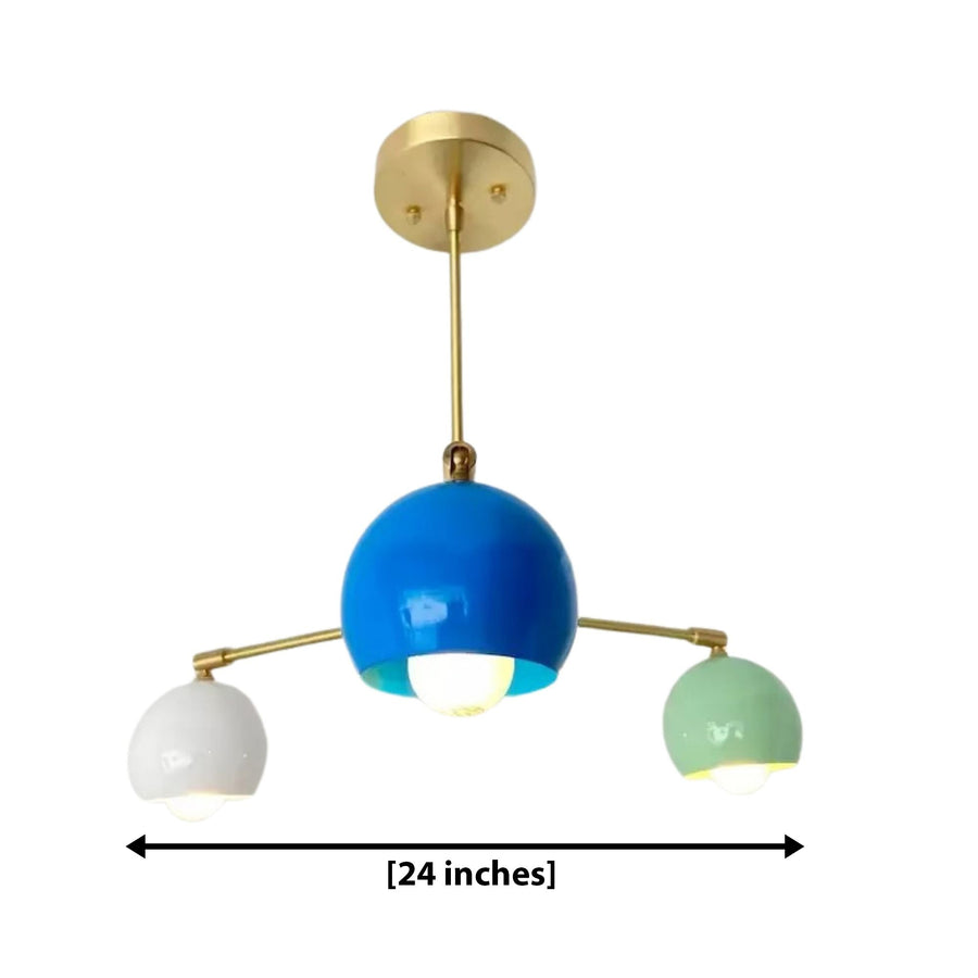 Geneva 3 light chandelier shown from the front with a large blue central dome, white and mint green side shades and brass-tone detailing.