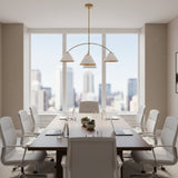 Genoa 4 light sculptural chandelier with white cone shades and warm brass interiors shown illuminated from an angled view.