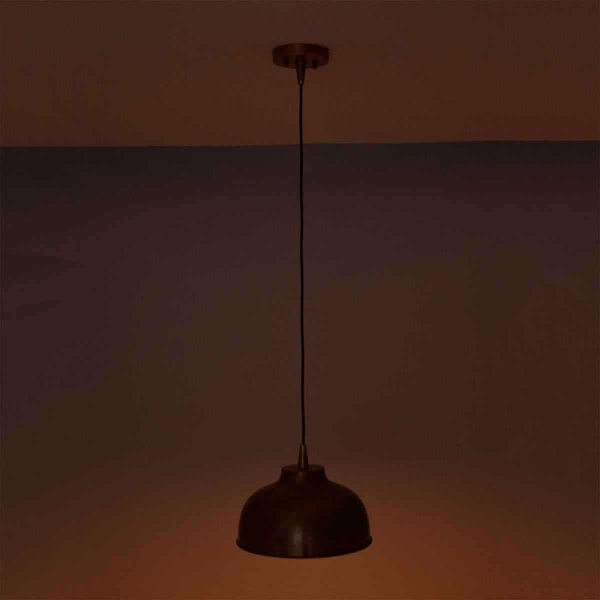 Hudson copper dome pendant light providing focused downward illumination with a warm copper reflection.