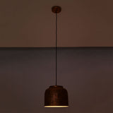 Hudson hammered copper dome pendant light at night emitting warm focused downward illumination