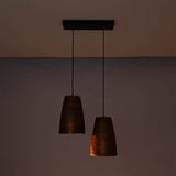 Hudson handcrafted copper dual cone pendant light illuminated with warm ambient lighting highlighting the textured metal finish.