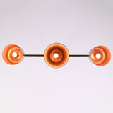 Bottom view of the Hudson Modern Linear Three Shade Chandelier displaying the illuminated interiors of the three handcrafted metal shades.