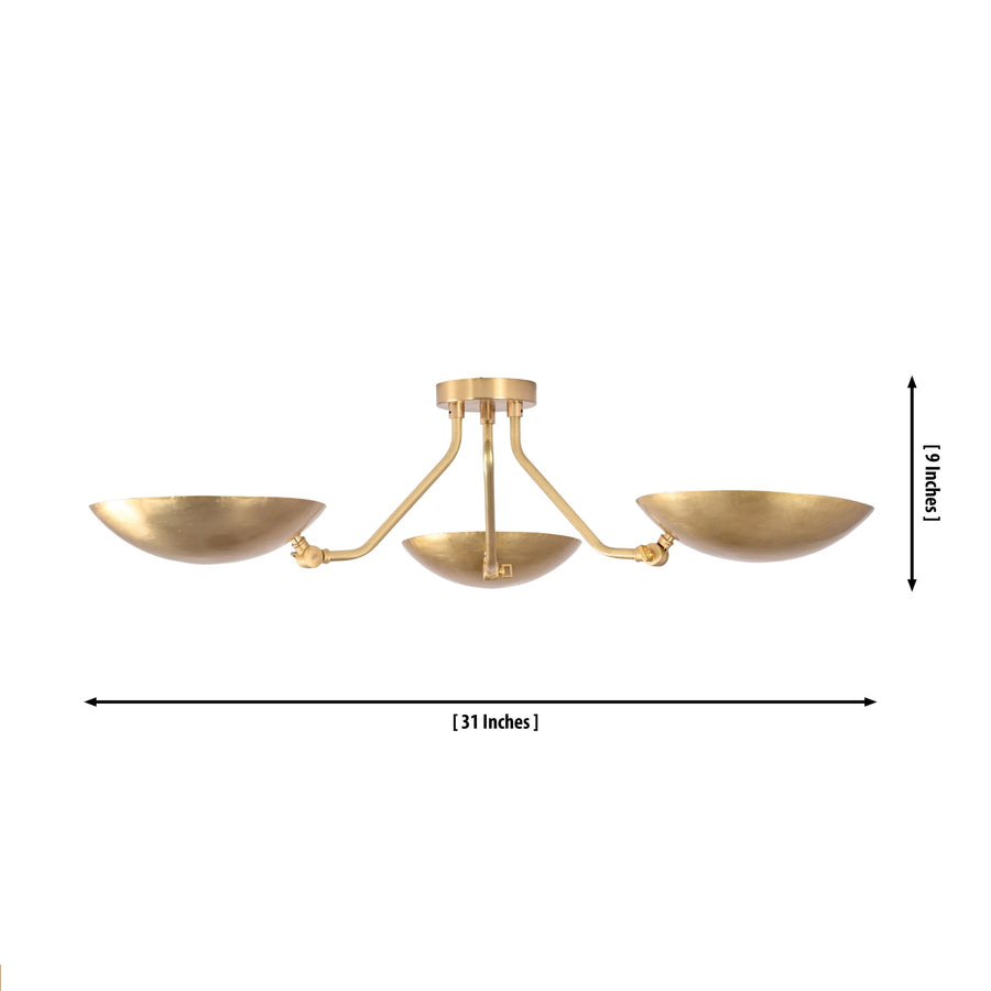 Hudson Mid-Century Modern triple dish brass chandelier installed in a contemporary living room with warm indirect ambient illumination.
