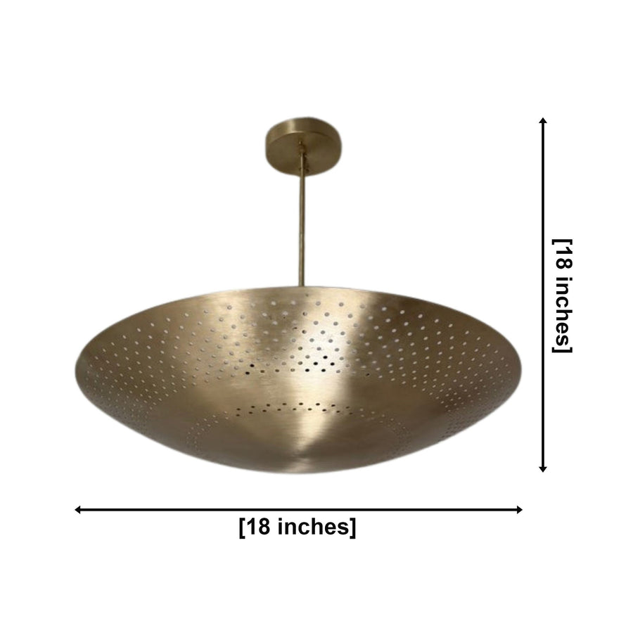 Ibiza 5 light brass perforated disc chandelier illuminated in an elegant modern living room with warm ambient lighting.