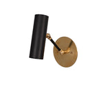 Front angled view of minimalist brass wall spotlight with matte black cylindrical shade