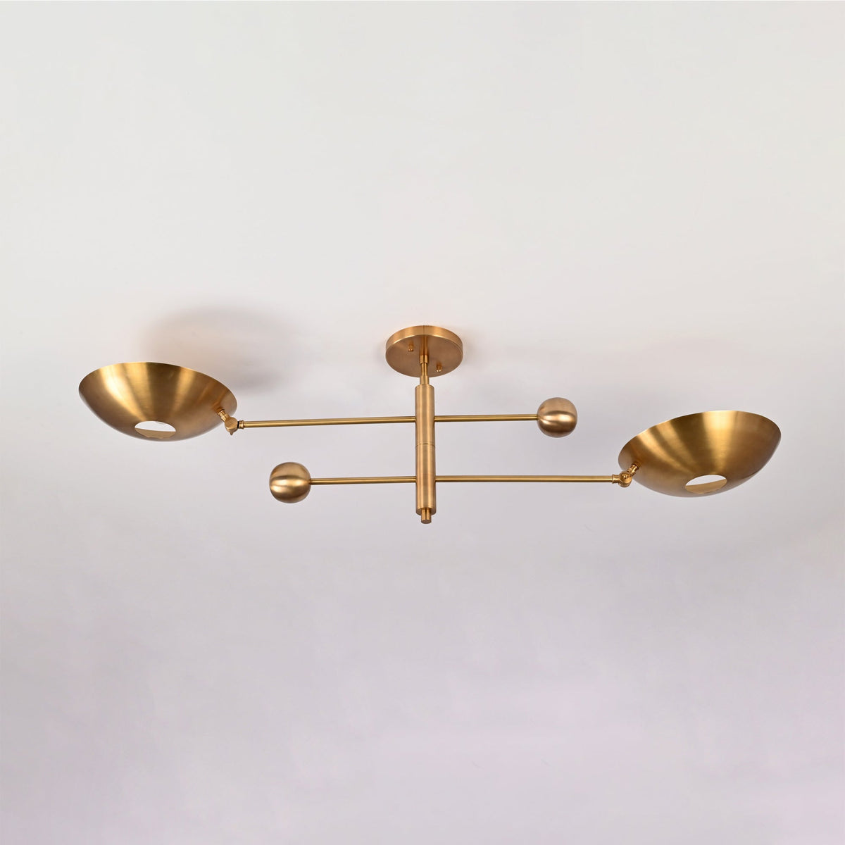 Angled front view of the Luna Modern Double Bowl Chandelier showcasing its minimalist linear silhouette and upward-facing bowl shades