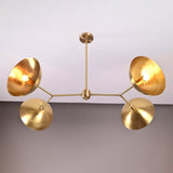 Madrid Orbital Chandelier glowing warmly on ceiling, creating dramatic shadows from angled disc shades.