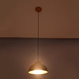Bright illuminated view of the Marlow hammered copper dome pendant light featuring a textured copper dome with warm focused lighting.