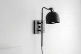 Matte black swing arm wall sconce with dome shade and adjustable arm, modern industrial wall lamp on square backplate
