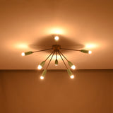 Modern mint and brass flush mount chandelier glowing warmly – room view