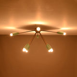 8-light brass and mint enamel flush mount chandelier glowing from ceiling