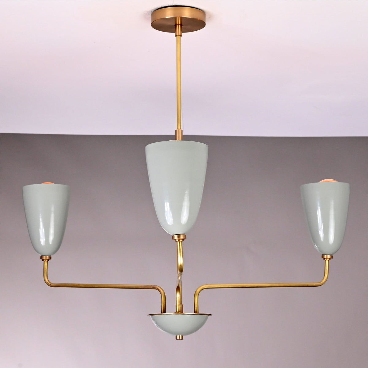 Close up of Milan Cone Arm Chandelier highlighting glossy cone shades, curved arms, and slim ceiling stem.