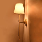 Side angle of Milan white shade wall sconce showing warm light effect and wall projection.