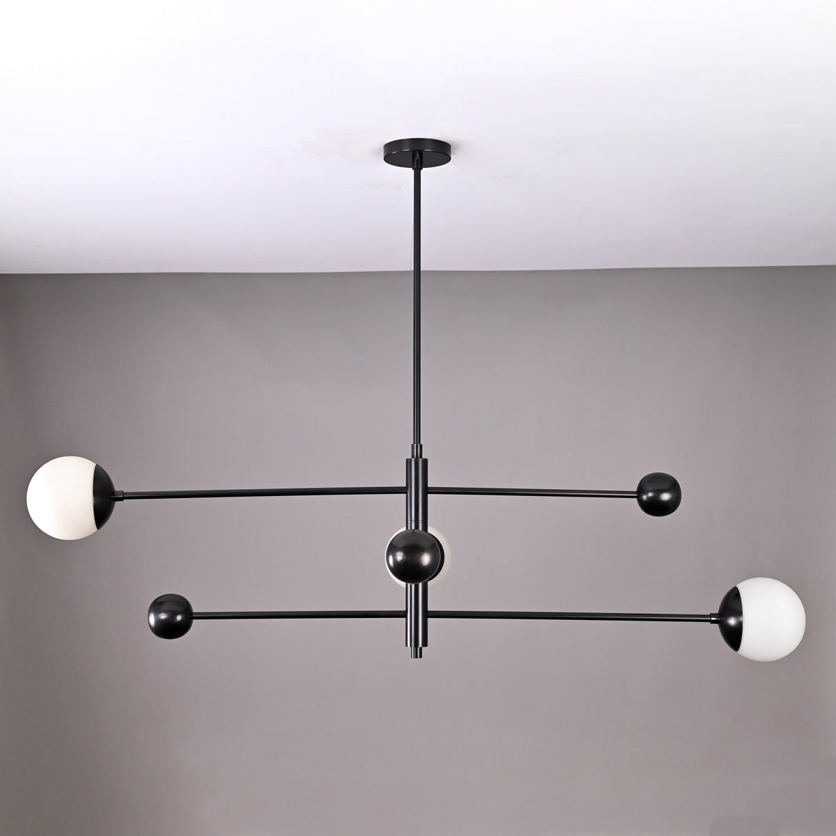 Modern 3-light matte black orb balance chandelier with brass arms – front view