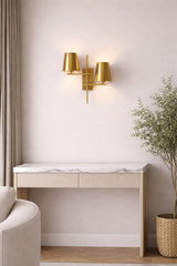 Styled interior view of a brass double wall sconce above a marble-top console table in a neutral modern room.