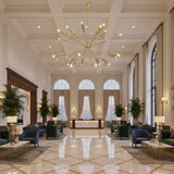 Nantes 24 light brass tone Sputnik chandelier shown with round ceiling canopy, downrod, radial arms, and cylindrical bulb holders.