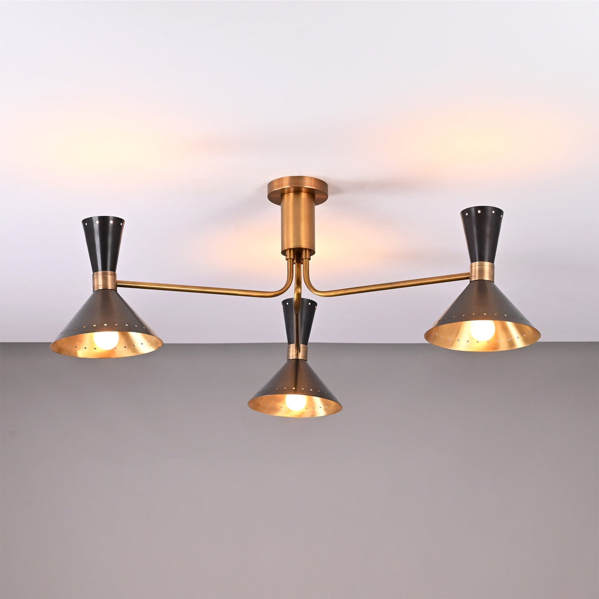Front view of Oslo Cone Arm Chandelier with three cone shades, slim arms, and compact ceiling mount.