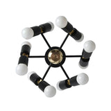 Prague 12 light sculptural chandelier shown from the top with black cylindrical holders, radial arms, brass-tone accents, and exposed white bulbs.