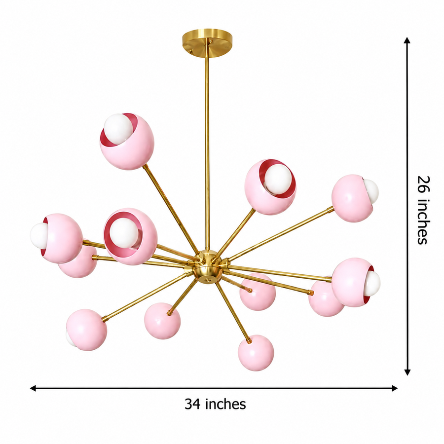 Rhodes 12 light pink globe Sputnik chandelier illuminated in a cozy bedroom with a polished brass frame.