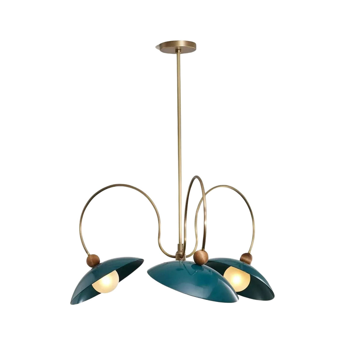 Rouen 3 light teal dome chandelier shown illuminated from an angled view with sculptural brass-tone loop arms and wood-tone accents.