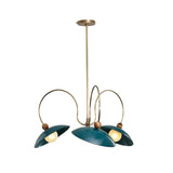 Rouen 3 light teal dome chandelier shown illuminated from an angled view with sculptural brass-tone loop arms and wood-tone accents.