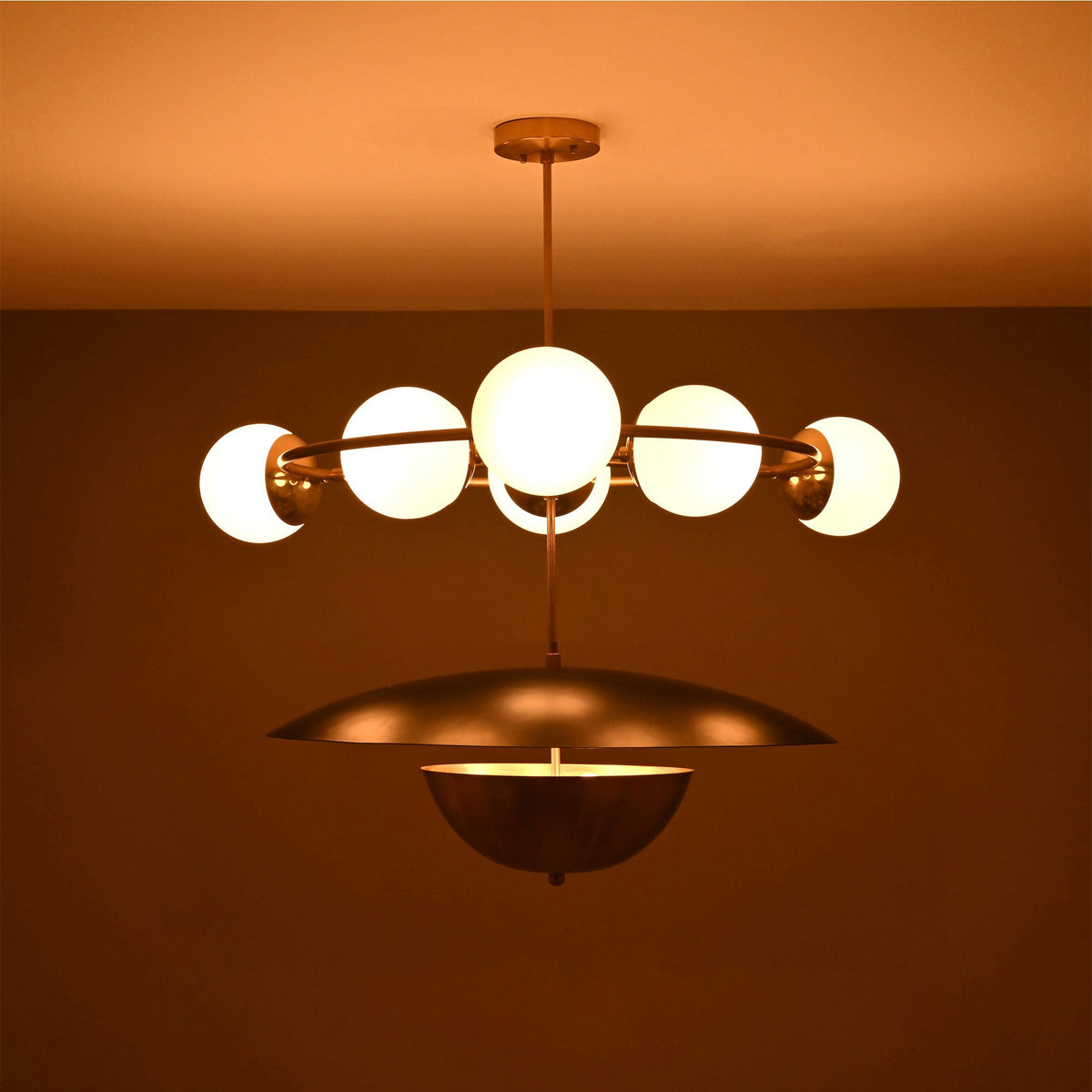 Siena Globe Disc Chandelier side view showing glowing globe lights, circular arm frame, and warm ceiling illumination.