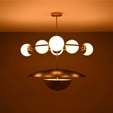 Siena Globe Disc Chandelier side view showing glowing globe lights, circular arm frame, and warm ceiling illumination.