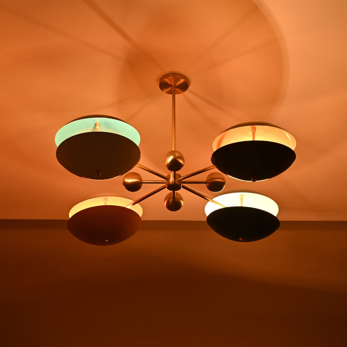 Siena Orbit Globe Chandelier installed on ceiling with warm light effect and colorful layered shades.