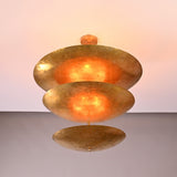 Siena Three Tier Disc Chandelier installed on ceiling, showing sculptural stacked disc form and soft reflected lighting.