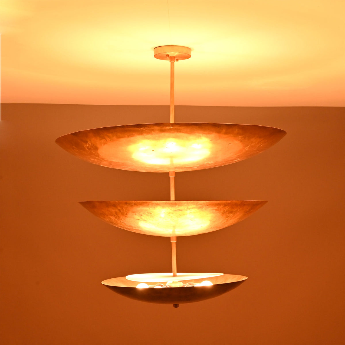 Siena Three Tier Disc Chandelier close-up with glowing stacked discs, ideal for modern dining and living spaces.