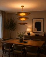 Siena Three Tier Disc Chandelier styled above a dining table in a warm modern interior with ambient lighting.