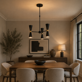 Singapore 6 light black double-cone chandelier illuminated above a wooden dining table in a warm contemporary dining room.