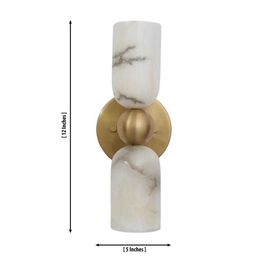 Sloane Dual Alabaster Cylinder Wall Sconce installed in a sophisticated modern interior, providing warm ambient lighting above a wooden console table with elegant décor.