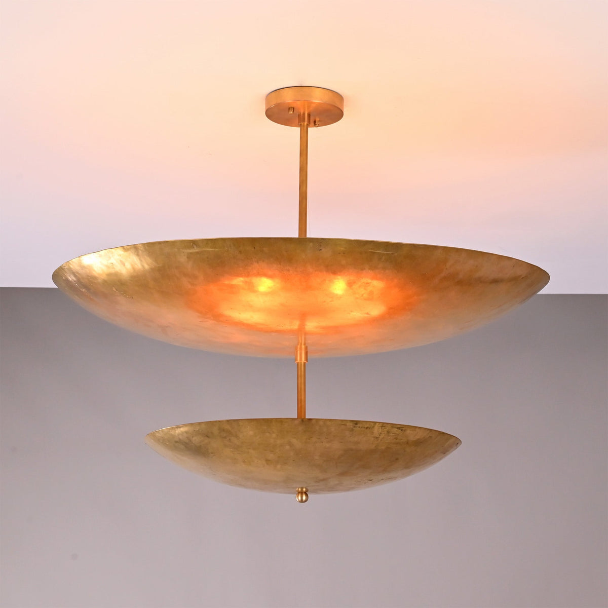 Front view of Solara Double Saucer Pendant Light with two layered saucer shades and warm glow.